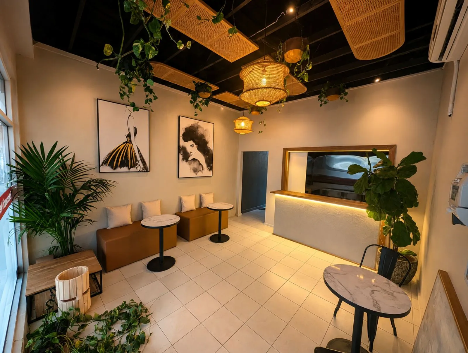 Cafe — lounge with serving counter, rattan pendant lights and leafy plants